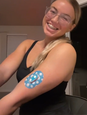 Woman with Painted Daisies Dexcom G6 Mini Tape and Transmitter Sticker on arm