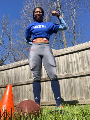 ExpressionMed Girl outside with football and Red Camo Dexcom G6 Tape and Red Camo Pod Tape