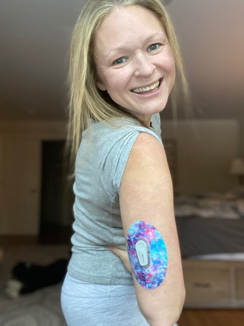 Smiling woman with Ascendant, The Rise Dexcom G6 Tape on arm