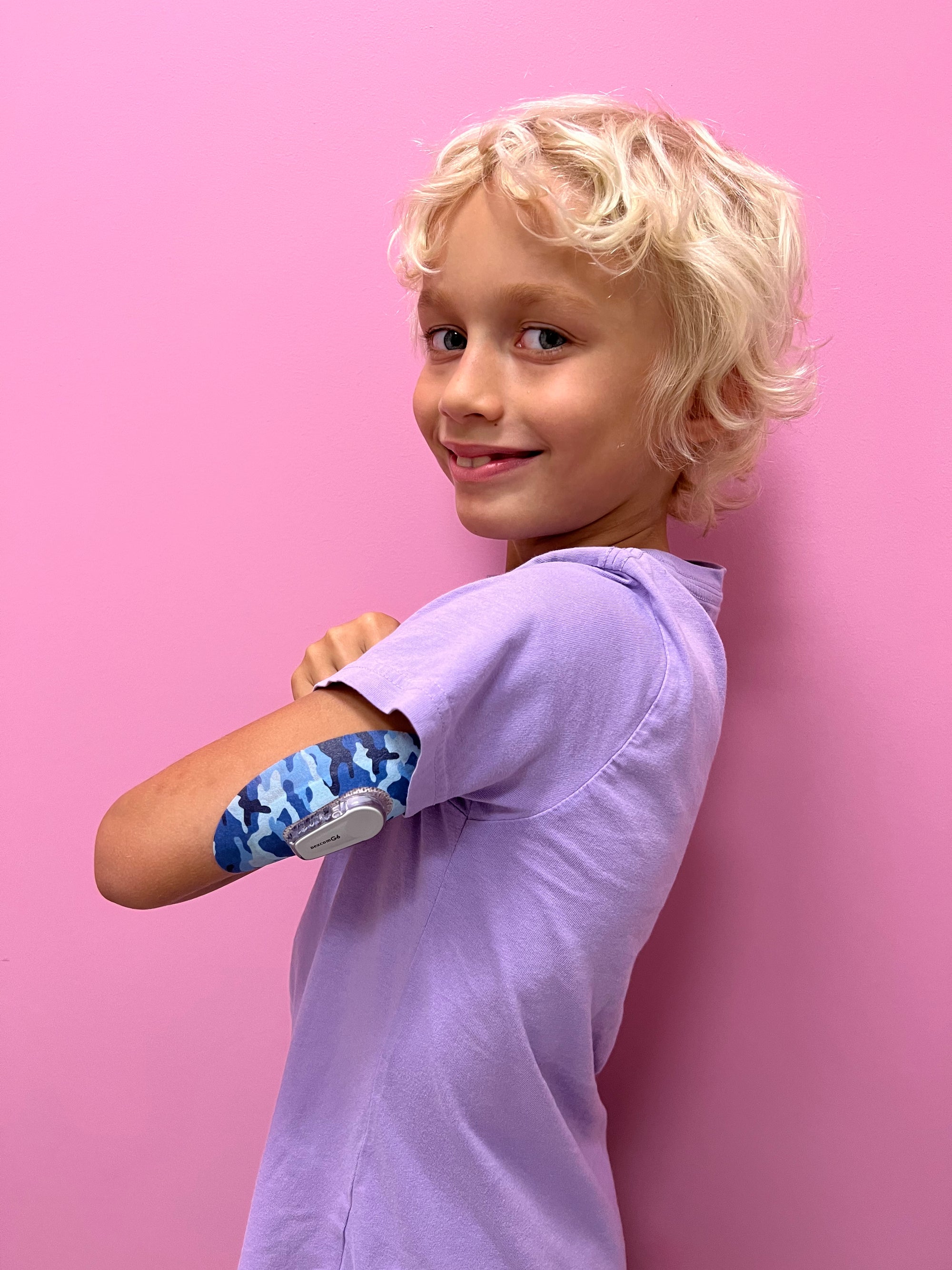 Young boy with Blue Camo Dexcom G6 Tape on arm
