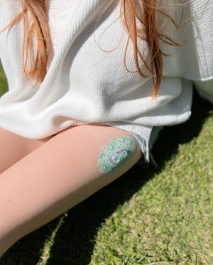 ExpressionMed Airy Floral Dexcom G6 with Center Vinyl Sticker, Female wearing device and tape on leg