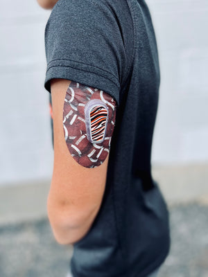 Bengals themed center sticker with football design cgm verlay tape on boy - ExpressionMed