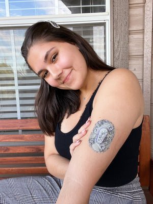 Woman wearing Dexcom G6 CGM with Black Lace Dexcom G6 Mini tape and matching vinyl center sticker - ExpressionMed