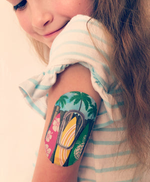 young girl wearing dexcom g6 transmitter with yellow surfboard overpatch