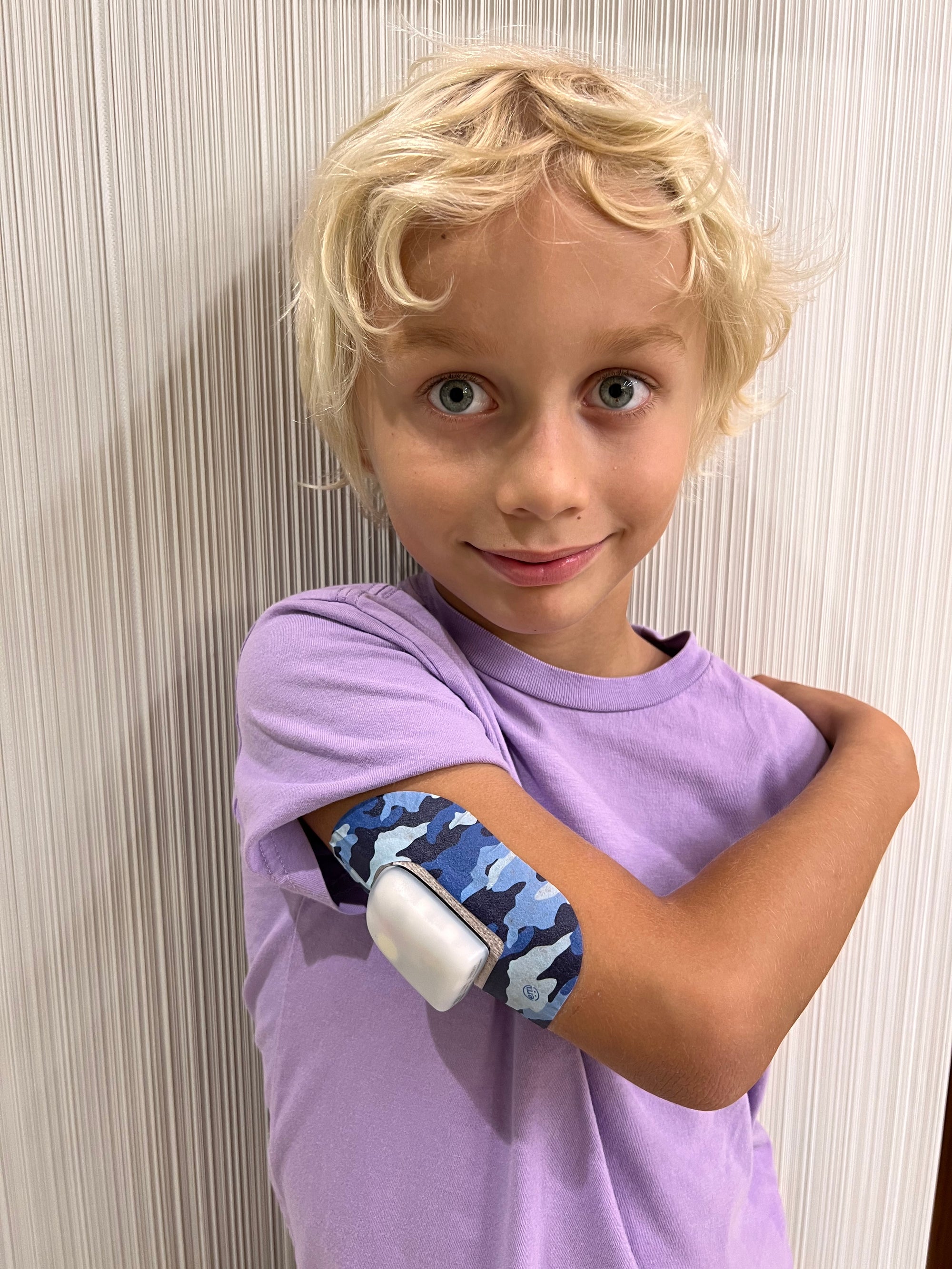 Young boy with Blue Camo Pod Tape on arm