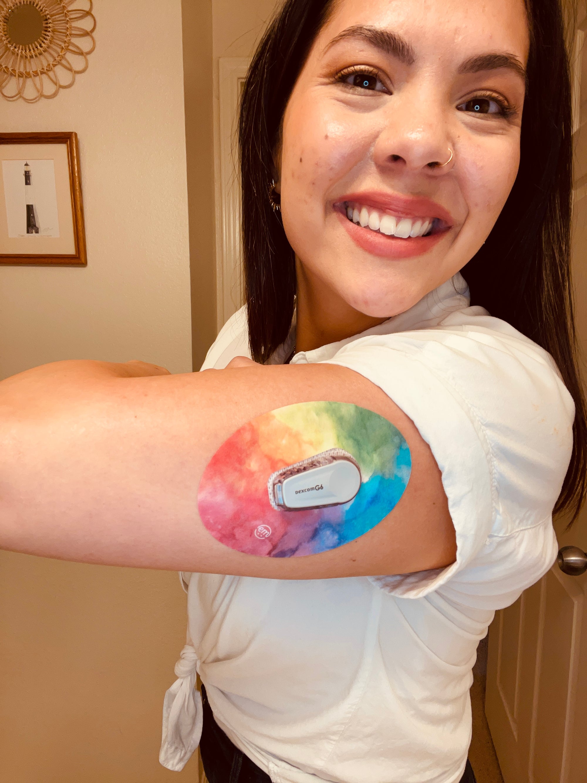 ExpressionMed Woman smiling with Rainbow Clouds Dexcom G6 Tape on arm